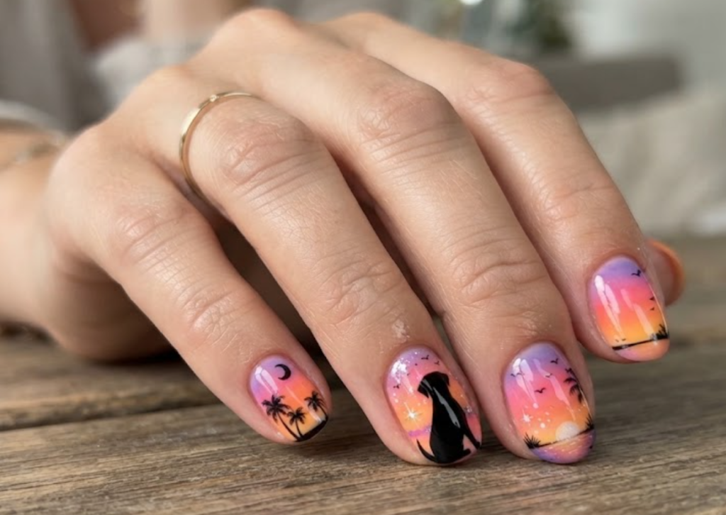 In this image, cartoonish sitting dog silhouette nails with sunset art