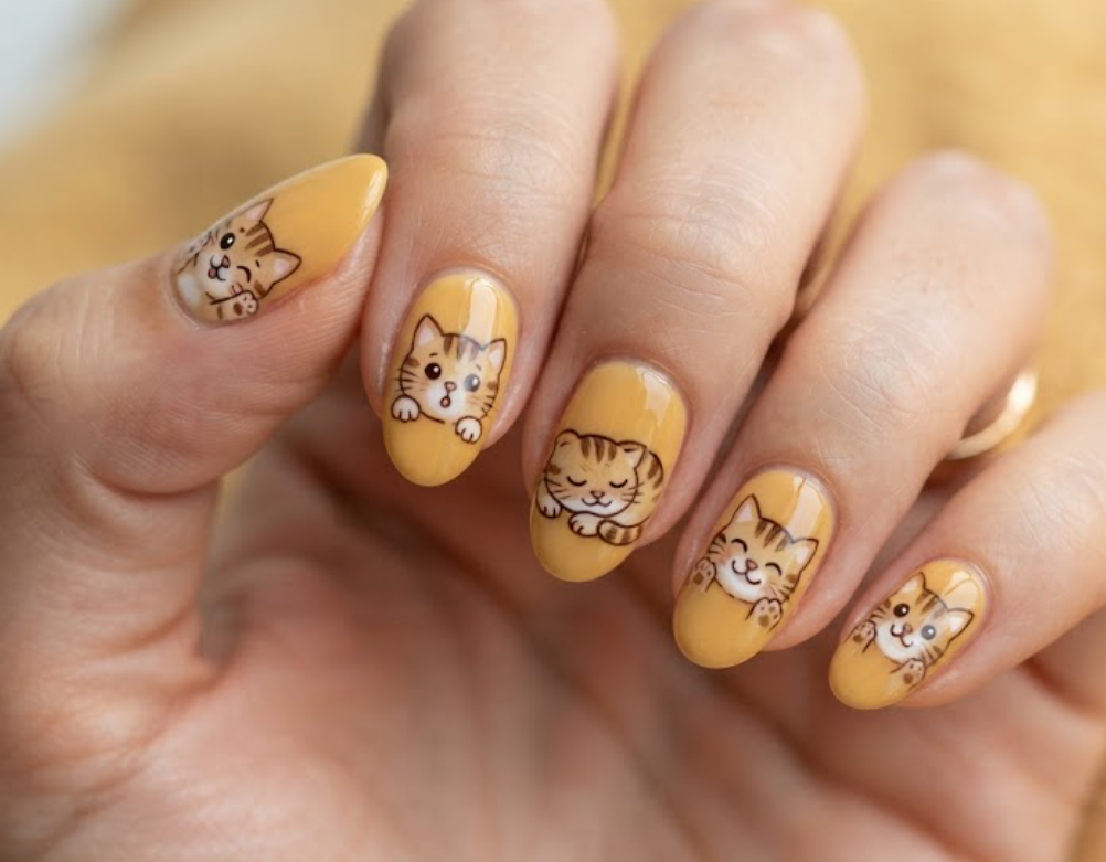In this image, honey yellow nails with striped cartoon tabby cat faces