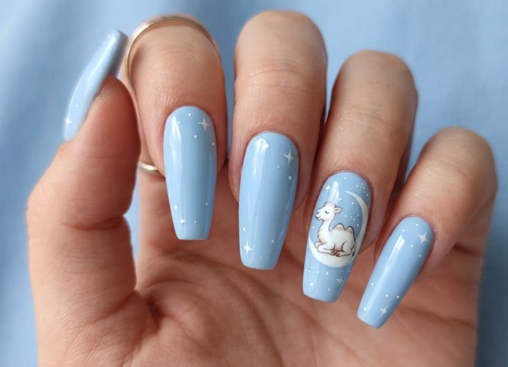 imaIn this image, baby blue nails with a white cartoon camel under a moon