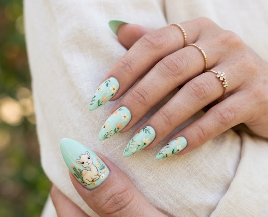 iIn this image, mint green nails with a cream cartoon camel and flowers