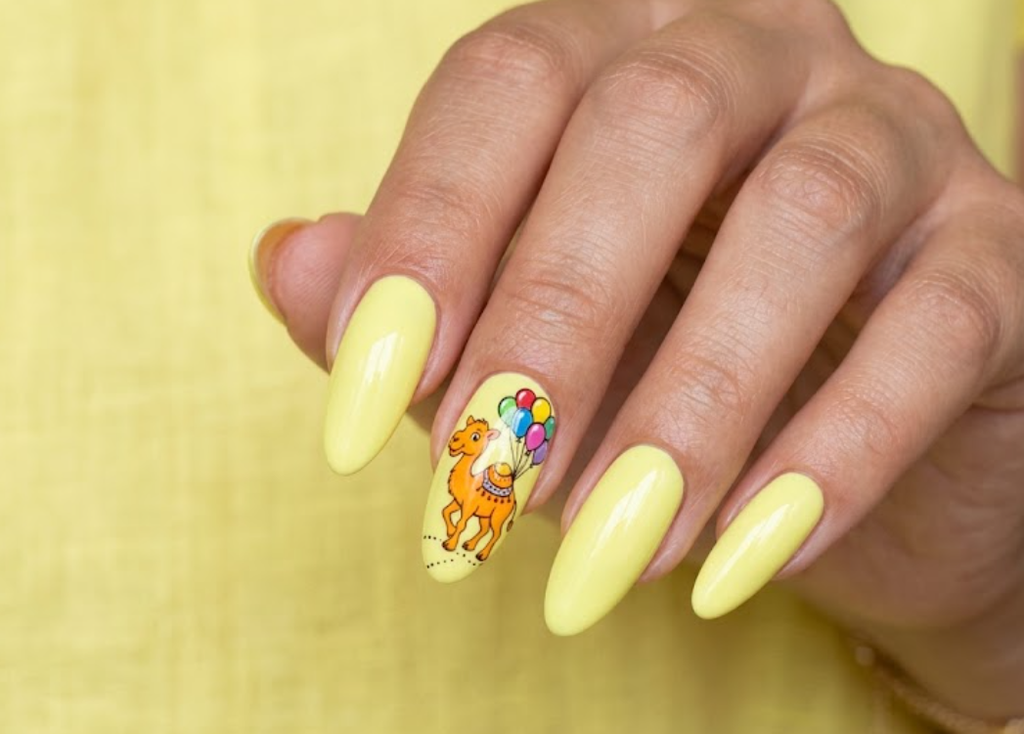 In this image, lemon yellow nails with a tangerine cartoon camel and balloons