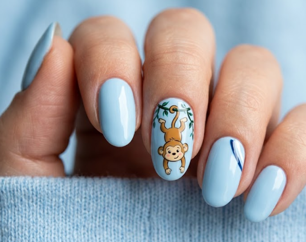 In this image, baby blue nails with a hanging cartoon monkey