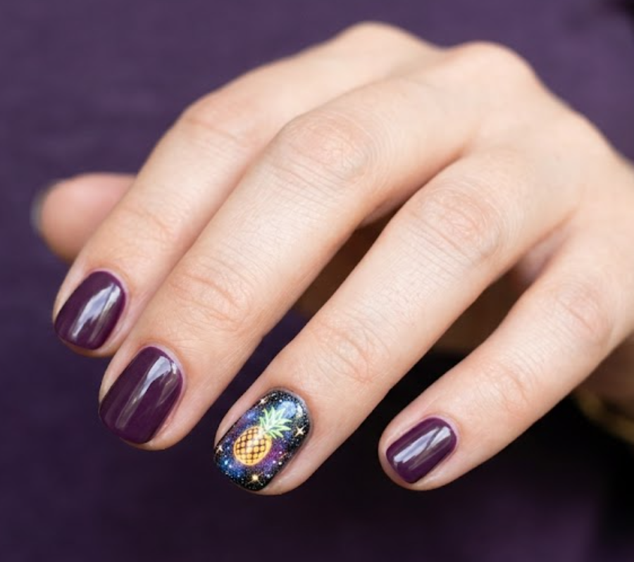 in this image, a hand in a purple shirt highlights a cosmic galaxy space background with a pineapple.