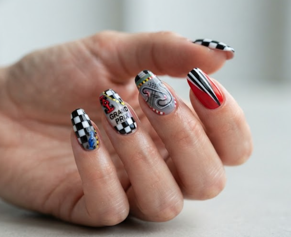 In this image, racing nails with checkered flags, racing cars, speed stripes, and track details.
