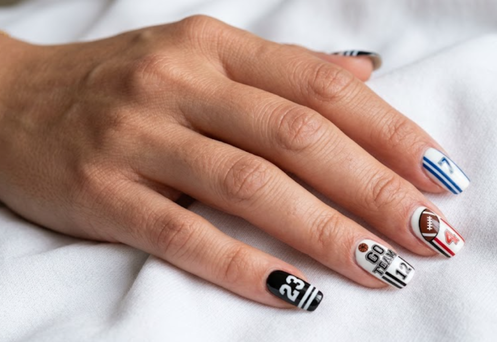 In this image, sports jersey nails with bold numbers, footballs, basketballs, and team stripes.