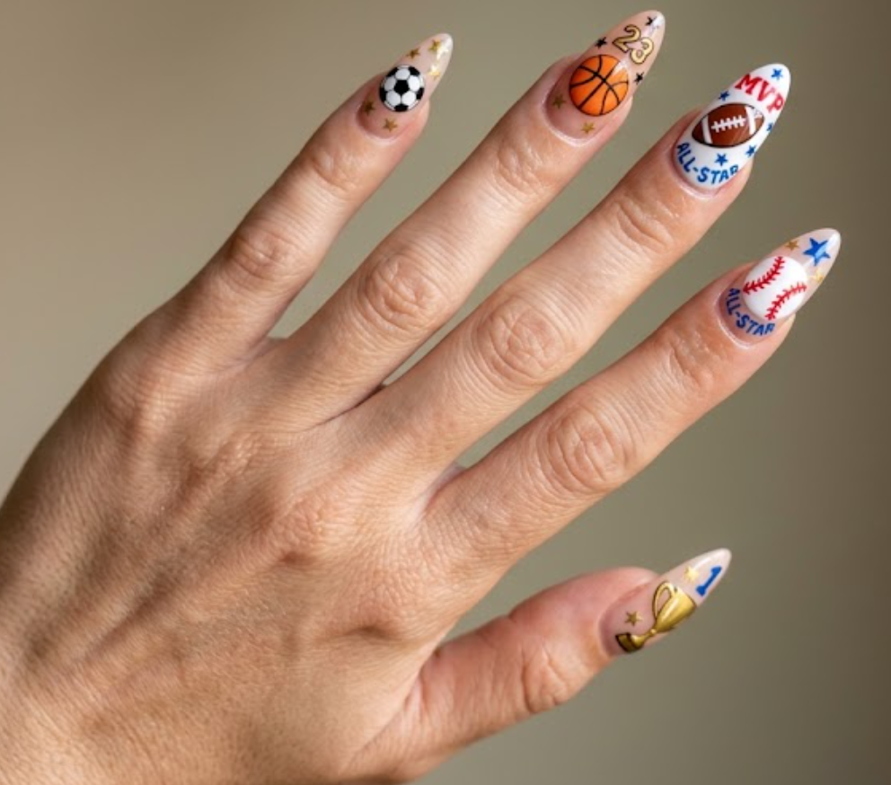 In this image, all-star sports nails featuring soccer balls, basketballs, footballs, baseballs, trophies, stars, and jersey numbers.