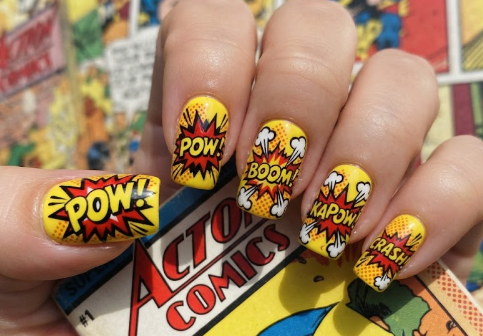 In this image, red and yellow comic nails feature bold POW lettering and pop-art explosion details.