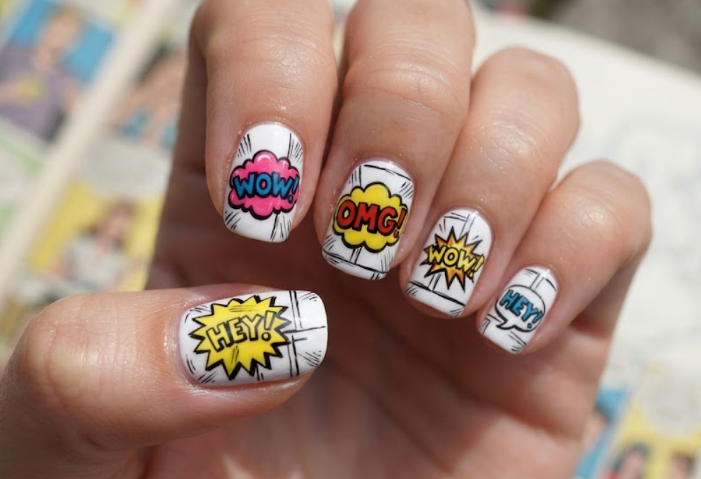 In this image, white comic nails feature colourful speech bubbles, fun expressions and cartoon panels.